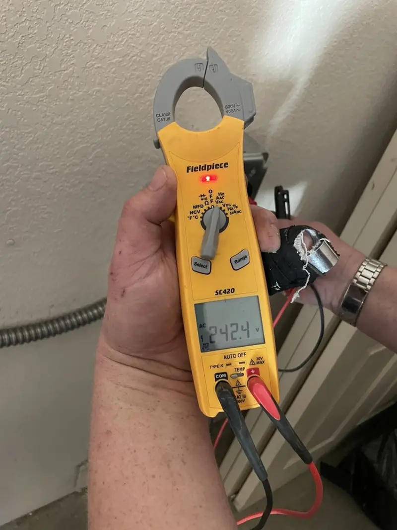 Voltage testing with clamp meter during Whole House Surge Protector in Morgan's Point Resort
